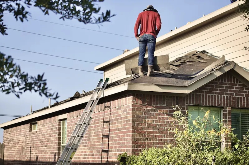 Professional roofer working on a residential roof in Westfield
